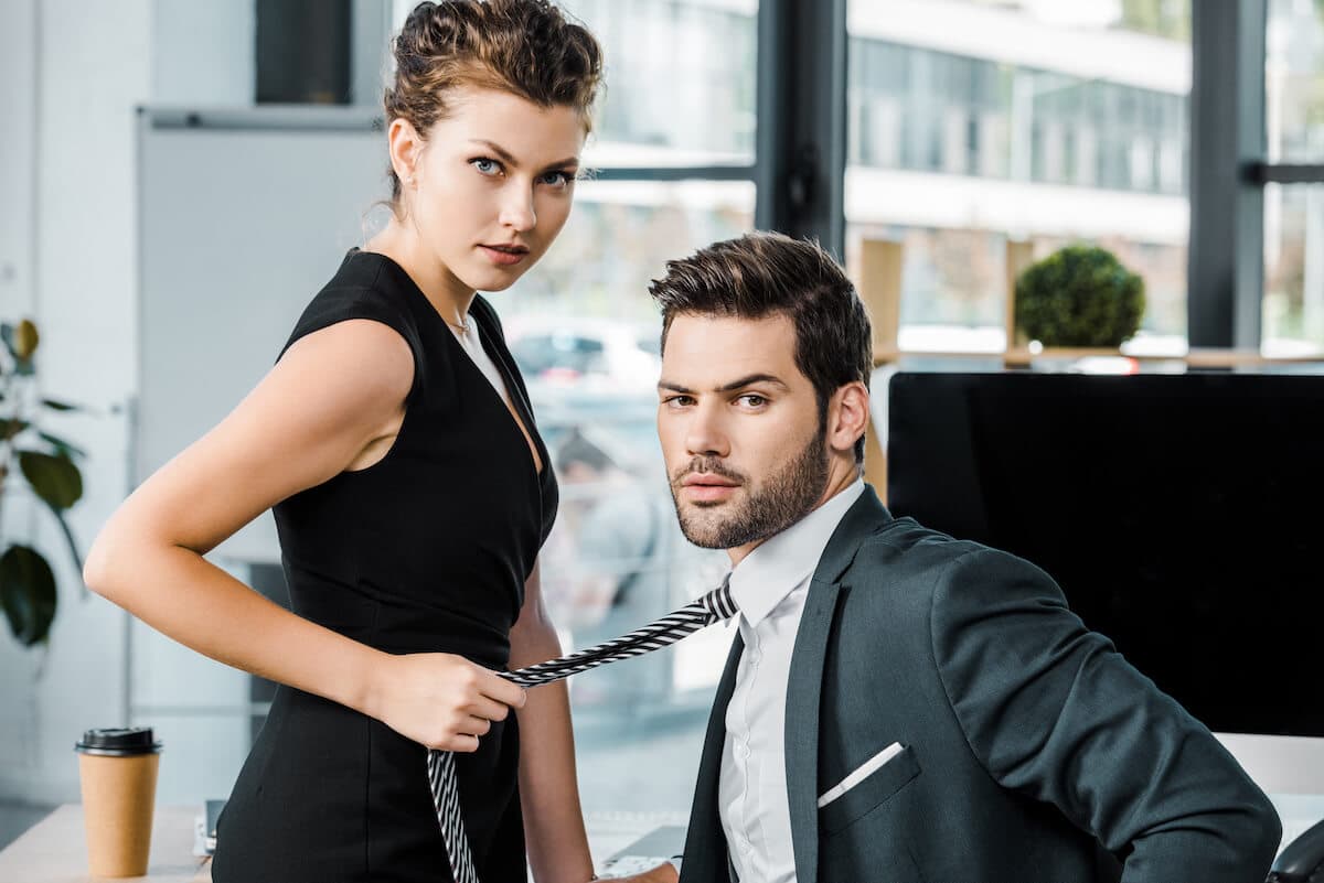 side-view-of-businesswoman-holding-colleagues-tie-2022-01-19-00-05-06-utc