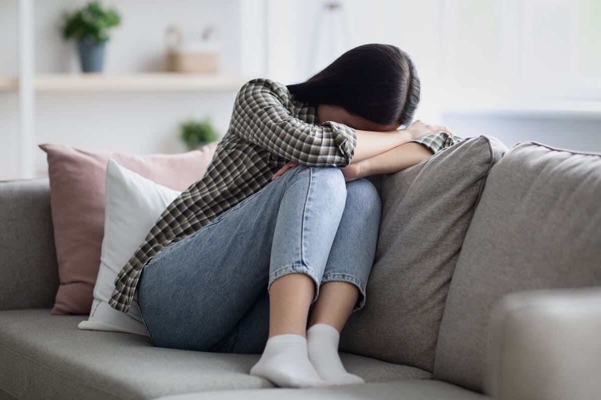 upset-young-woman-sitting-on-couch-and-crying-2021-09-03-04-19-11-utc