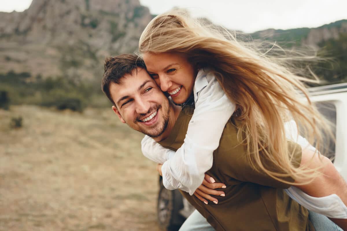 happy-loving-couple-hiking-and-hugging-in-mountain-2022-01-18-23-38-21-utc